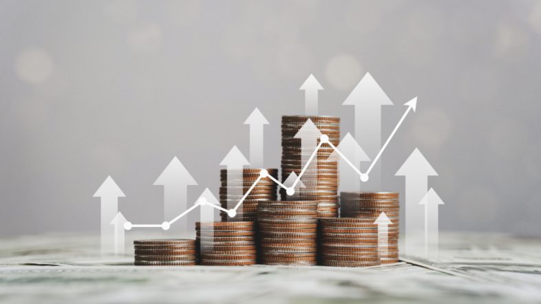 stack of silver coins with trading chart in financial concepts and financial investment business stock growth.